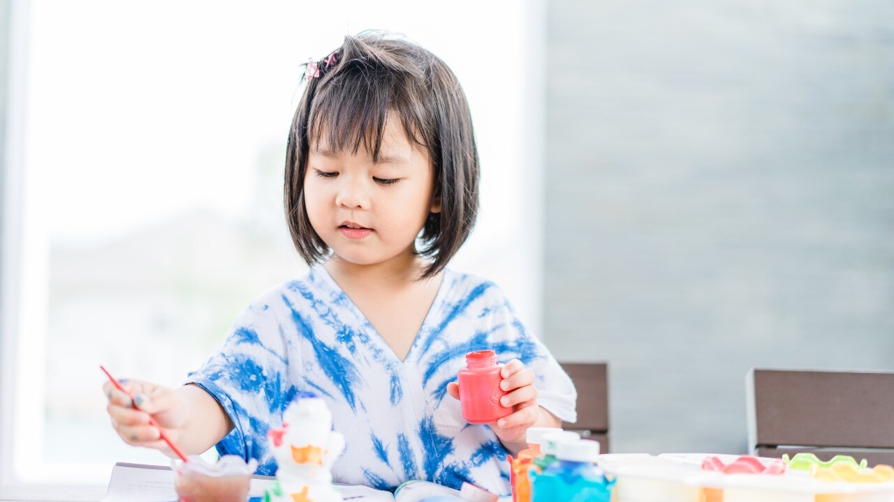 Little girl painting.